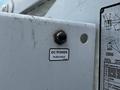 A close-up view of a white control panel featuring a labeled button for DC power with the text "DC POWER PUSH/HOLD" and a small blue indicator next to it