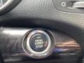 Close-up of the engine start-stop button in a 2015 Kia Sorento interior with a black textured surface surrounding it