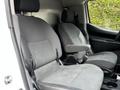 Two gray upholstered front seats of a 2020 Nissan NV200 van with adjustable headrests and armrests
