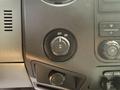 Close-up of a control knob in a 2011 Ford F-350 SD with markings for ON and OFF among other buttons and dials for vehicle settings