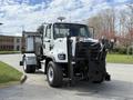 A white 2016 Freightliner 108SD truck with a flat front and a plow attachment mounted on the front facing forward
