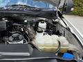 2020 Ford F-350 Super Duty engine compartment displaying the coolant reservoir and various engine components