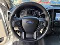 Steering wheel of a 2019 Ford F-550 featuring controls and the Ford logo in the center