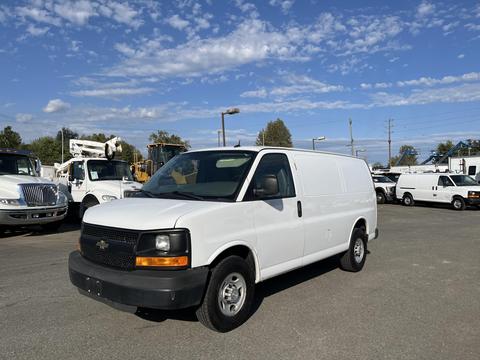 A white 2014 Chevrolet Express van facing slightly to the right with a dark grille and headlights visible