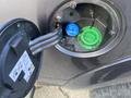 Close-up of the fuel filler cap of a 2017 RAM 1500 showing two ports one blue marked for gasoline and one green labeled diesel only