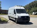 A 2019 Mercedes-Benz Sprinter van with a white exterior and black front bumper parked on a road