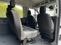 Interior of a 2022 Ford Transit showing two front seats and two rear captain's chairs with fabric upholstery