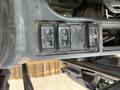 Close-up of control switches on a 2018 John Deere 350 featuring labels for lights, wipers, and a power option