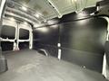 Interior of a 2020 Ford Transit cargo van with a spacious empty cargo area featuring a flat floor and paneled walls
