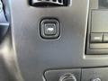 Close-up of the dashboard controls in a 2014 Chevrolet Express showing a button with a trailer icon and various audio controls