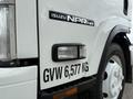 A white 2017 Isuzu NPR HD truck featuring the model name on the side and a label indicating a gross vehicle weight of 6577 kg