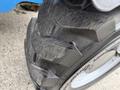 Close-up of a tire from a 2020 Genie GTH-5519 featuring deep treads designed for traction and stability in rugged conditions