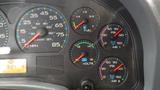 Dashboard of a 2005 International 4300 showing various gauges for speed fuel volts and air pressure