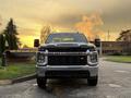 A 2023 Chevrolet Silverado 3500HD is prominently displayed in the foreground with a bold front grille and headlights showcasing its robust design