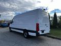 A 2022 Mercedes-Benz Sprinter van in white with a high roof and cargo area, featuring rear doors and a sleek design