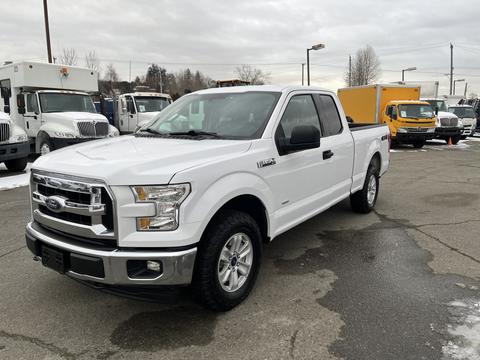 A white 2017 Ford F-150 pickup truck with a double cab and chrome grille parked in an outdoor lot