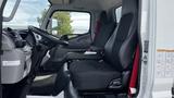 Interior of a 2018 Mitsubishi Fuso FE featuring two black seats with red accents and a dashboard with various controls and displays