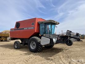 A red Massey Ferguson 8680 combine harvester with large tires and a front-mounted header designed for grain harvesting