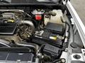 Close-up of the engine compartment of a 2021 Chevrolet Silverado 3500HD showing the battery and various fluid reservoirs