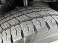 Close-up of a rugged tire on a 2020 Ford Transit showcasing deep treads and slight dirt accumulation