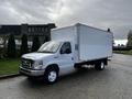 A white 2019 Ford Econoline box truck with a large empty cargo area and standard wheels parked on a paved surface