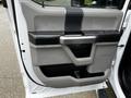 Interior door panel of a 2017 Ford F-550 featuring grey and black plastic trim with a handle and storage compartment
