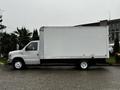 A white 2017 Ford Econoline box truck with a large blank cargo area on the back parked on a concrete surface