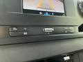 Close-up of the control panel in a 2023 Mercedes-Benz Sprinter featuring buttons for phone, media, and volume adjustment