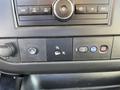 Dashboard controls of a 2014 Chevrolet Express featuring buttons for various functions including power, settings, and safety alerts