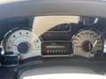 The dashboard of a 2013 Ford Expedition showing speedometer and fuel gauge with various indicator lights and a digital odometer displaying 0588