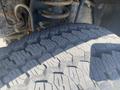 Close-up of a rugged tire tread on a 2014 Ford F-250 SD showcasing deep grooves and aggressive patterns designed for off-road traction