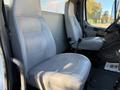 Two gray leather seats in the cabin of a 2011 Freightliner M2 106 with a visible seatbelt and dashboard area