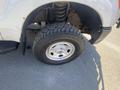 A close-up view of a 2016 Ford F-350 SD's front tire showing the silver wheel and a rugged tread pattern