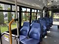 Interior view of a 2020 Chevrolet Express with blue seats arranged in rows and seatbelts visible