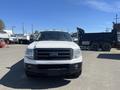 A white 2013 Ford Expedition is parked and facing forward with a black front grille and no visible license plate