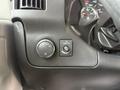 Close-up of the dashboard controls of a 2020 Chevrolet Express featuring light settings and a switch for auxiliary functions