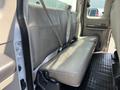 Interior view of the backseat of a 2008 Ford F-450 SD featuring beige leather upholstery and seat belts installed