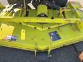 A 2010 Kubota F3990 lawn mower with a yellow deck and various mechanical components visible including blades and safety labels