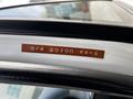 A metallic plaque displaying the numbers 5/4 20700 XX-E inside a 2003 Mitsubishi Delica above the door frame