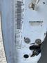 A close-up of a 2009 Dodge Ram 5500 door frame showing vehicle identification information and a damaged area near the hinge