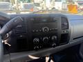 The interior dashboard of a 2013 Chevrolet Silverado 1500 featuring a central display and various controls for audio and climate settings