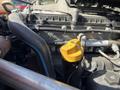 Close-up view of the engine of a 2022 Freightliner Cascadia showing various components including pipes and a yellow dipstick handle