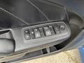 Interior door panel of a 2022 Dodge Charger showing window control buttons and a textured black surface