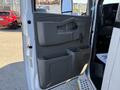 A 2019 Chevrolet Express van door interior featuring a gray panel with a handle and storage compartments