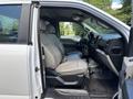 A 2016 Ford F-150 interior showcasing two front seats with light gray upholstery and a view of the dashboard and steering wheel