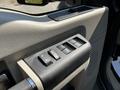 Interior control panel of a 2008 Ford F-550 featuring window controls in a sleek design with a textured surface