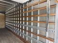 A 2022 International MV607 truck with wooden slats mounted on metal supports along a metal frame inside the cargo area