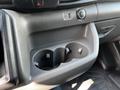 Interior view of a 2022 Ford Transit dashboard featuring a cup holder with three compartments and a power outlet with USB and 12V options