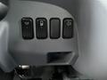 Controls on the dashboard of a 2012 Mitsubishi Fuso FE featuring four switches for lights fog lights and windshield wipers