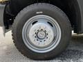 A close-up of a 2016 Ford F-550 wheel with a grey rim and rugged tire tread showing details of the wheel's multi-bolt pattern and the tire's brand name